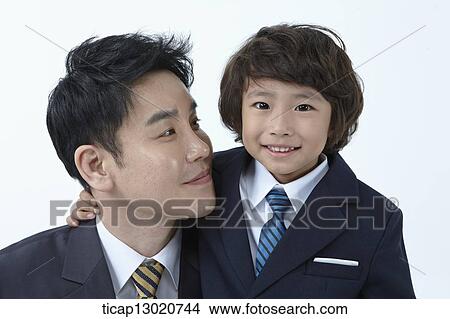 a boy dressed up as a business man with his father View Large Photo Image Picture - a boy dressed up as a business man with his father. Fotosearch