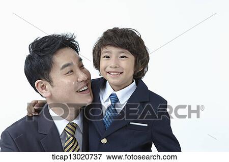 Stock Photo - a boy dressed up as a business man with his father. Fotosearch