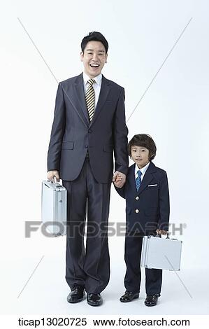 Stock Photography - a boy dressed up as a business man with his father. Fotosearch