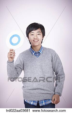 a boy holding a board saying correct View Large Photo Image Stock Image - a boy holding a board saying correct. Fotosearch