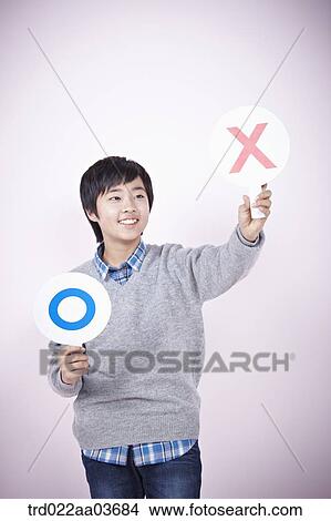 a boy holding boards saying correct and wrong View Large Photo Image Picture - a boy holding boards saying correct and wrong. Fotosearch