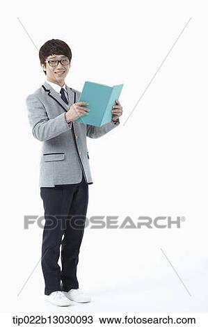 a boy in a school uniform reading a book View Large Photo Image Stock Image - a boy in a school uniform reading a book. Fotosearch