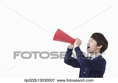 Stock Photo - a boy in school uniform with a paper megaphone. Fotosearch