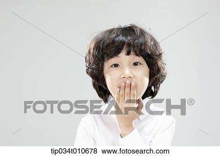 a boy in white shirt looking surprised View Large Photo Image Stock Photo - a boy in white shirt looking surprised. Fotosearch