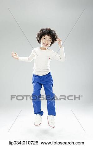 a boy jumping in the air View Large Photo Image Stock Photograph - a boy jumping in the air. Fotosearch