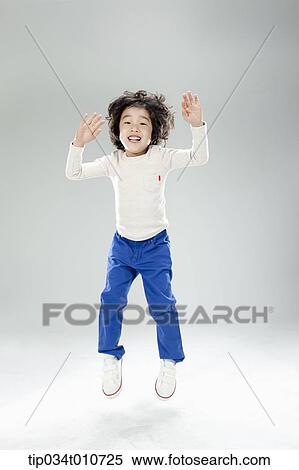 a boy jumping in the air View Large Photo Image Stock Photography - a boy jumping in the air. Fotosearch