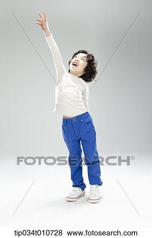 Stock Photo - a boy jumping to reach something. Fotosearch