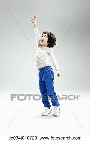 a boy jumping to reach something View Large Photo Image Stock Photo - a boy jumping to reach something. Fotosearch