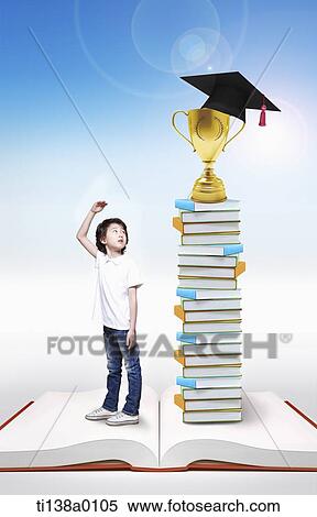 a boy standing next to a pile of books View Large Photo Image Stock Photography - a boy standing next to a pile of books. Fotosearch