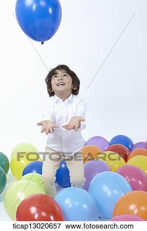 Stock Photo - a boy with a lot of balloons. Fotosearch