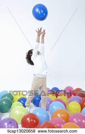 Stock Photo - a boy with a lot of balloons. Fotosearch