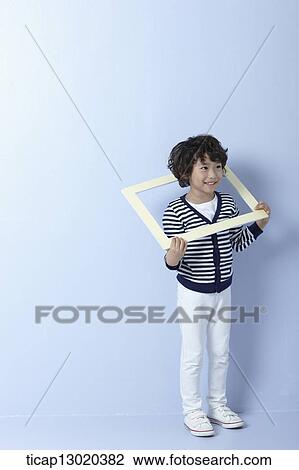 Stock Image - a boy with an empty frame. Fotosearch