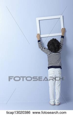 a boy with an empty frame View Large Photo Image Stock Photograph - a boy with an empty frame. Fotosearch