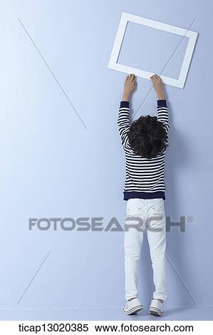 a boy with an empty frame View Large Photo Image Stock Photography - a boy with an empty frame. Fotosearch