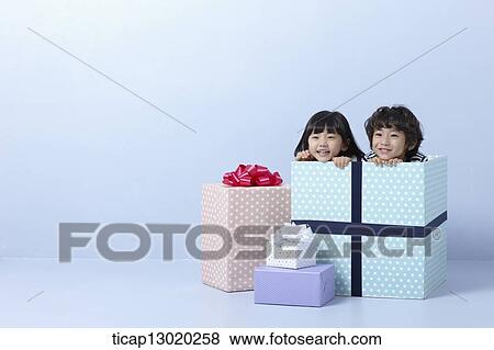 Stock Photo - a brother and a sister inside a present. Fotosearch
