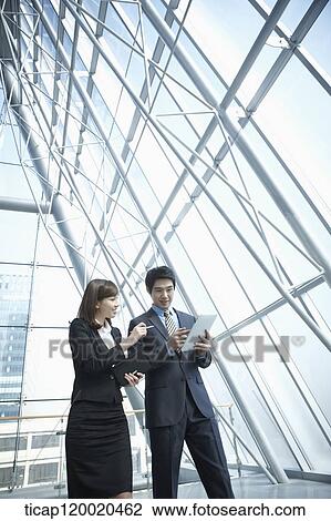 Stock Image - a business man and a business woman. Fotosearch