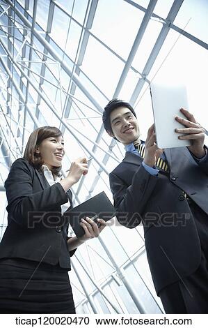 Stock Image - a business man and a business woman. Fotosearch