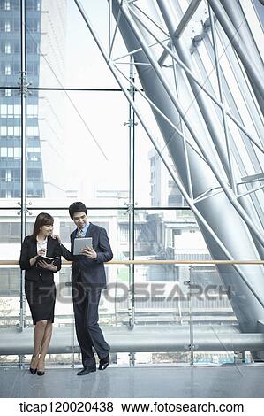 Stock Photo - a business man and a business woman. Fotosearch