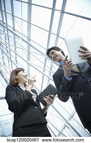 Stock Photo - a business man and a business woman. Fotosearch