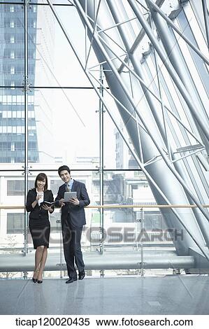 Stock Photography - a business man and a business woman. Fotosearch