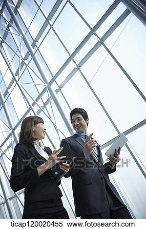 Stock Photography - a business man and a business woman. Fotosearch