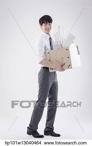 a business man carrying a box of stuff View Large Photo Image Picture - a business man carrying a box of stuff. Fotosearch