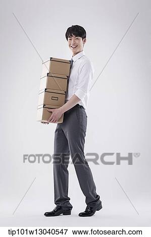 a business man carrying a pile of boxes View Large Photo Image Stock Photo - a business man carrying a pile of boxes. Fotosearch