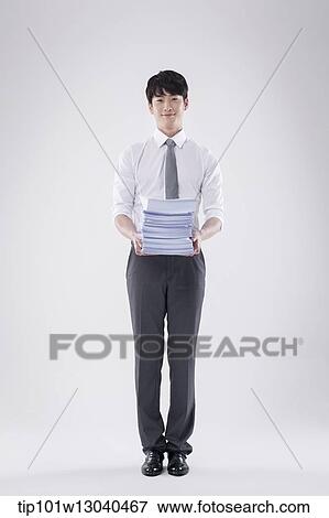a business man carrying a pile of papers View Large Photo Image Stock Photo - a business man carrying a pile of papers. Fotosearch