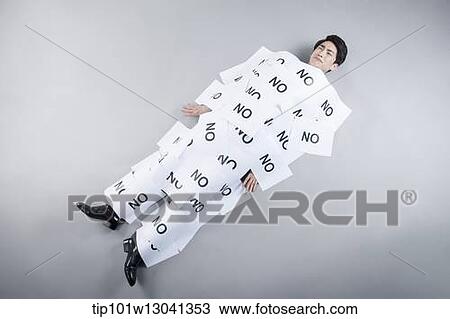 a business man covered by papers that say no View Large Photo Image Stock Image - a business man covered by papers that say no. Fotosearch
