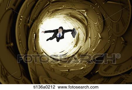 Stock Image - a business man flying in a cave. Fotosearch