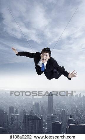Stock Image - a business man flying. Fotosearch