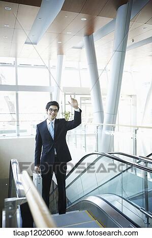 Stock Image - a business man going up the stairs. Fotosearch