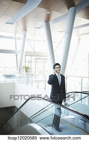 Stock Photography - a business man going up the stairs. Fotosearch