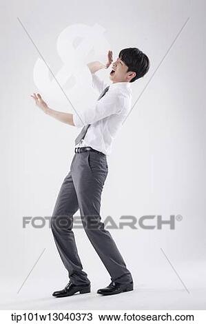 a business man holding a dollar sign View Large Photo Image Stock Image - a business man holding a dollar sign. Fotosearch