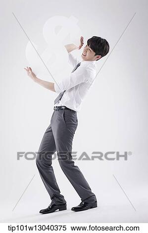 Stock Photography - a business man holding a dollar sign. Fotosearch