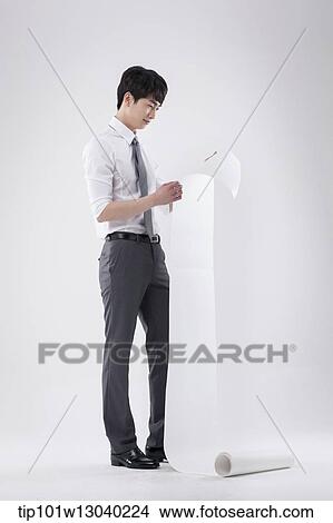 Picture - a business man holding a paper roll. Fotosearch