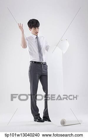 Stock Image - a business man holding a paper roll. Fotosearch