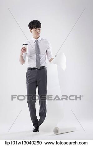 a business man holding a paper roll View Large Photo Image Stock Image - a business man holding a paper roll. Fotosearch