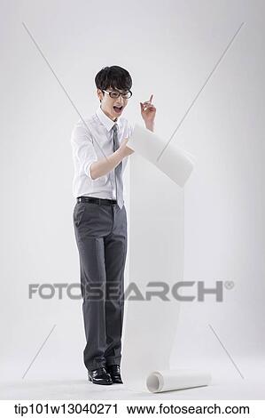 a business man holding a paper roll View Large Photo Image Stock Image - a business man holding a paper roll. Fotosearch