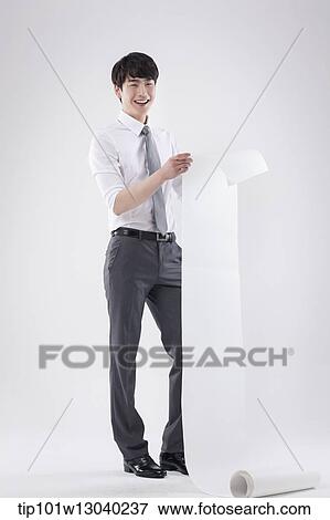 Stock Photo - a business man holding a paper roll. Fotosearch