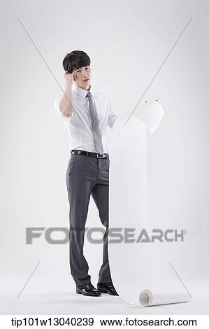 a business man holding a paper roll View Large Photo Image Stock Photo - a business man holding a paper roll. Fotosearch