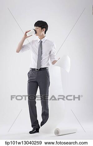 Stock Photo - a business man holding a paper roll. Fotosearch