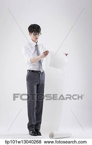 Stock Photo - a business man holding a paper roll. Fotosearch