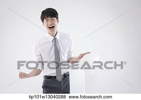 Stock Photo - a business man holding a paper roll. Fotosearch