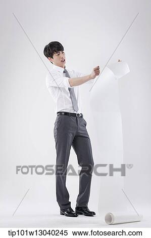 Stock Photography - a business man holding a paper roll. Fotosearch