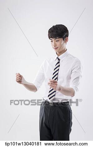 Stock Image - a business man holding a transparency sheet. Fotosearch