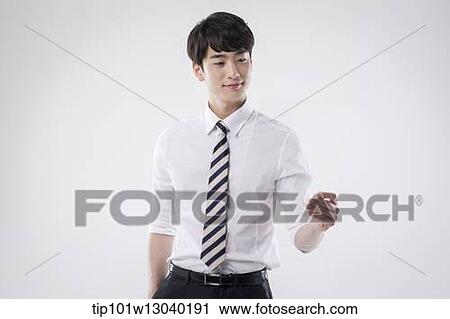 Stock Image - a business man holding a transparency sheet. Fotosearch