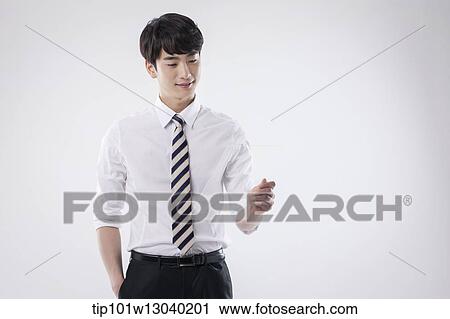 Stock Image - a business man holding a transparency sheet. Fotosearch