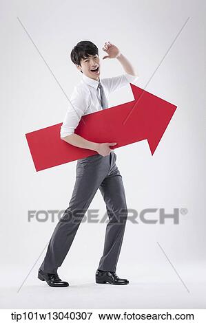 Stock Photo - a business man holding an arrow. Fotosearch