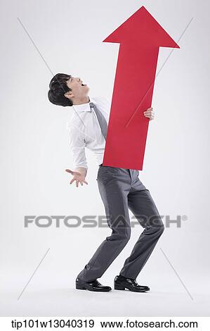 a business man holding an arrow View Large Photo Image Stock Photo - a business man holding an arrow. Fotosearch